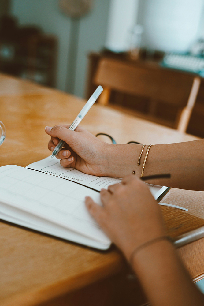 Person writing in a journal representing taking the quiz